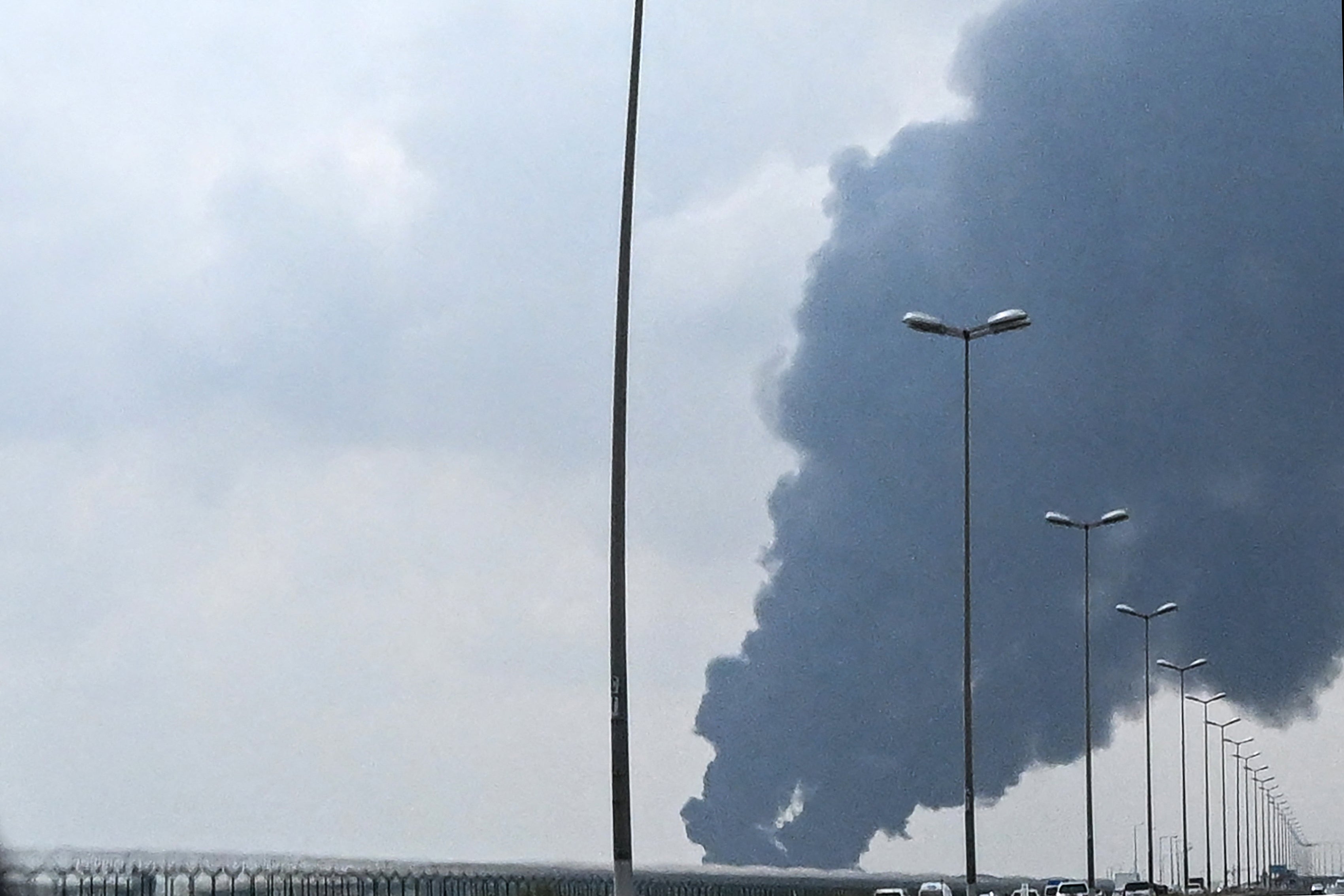 Smoke rises from the area of the Kuwait International Airport after a reported drone strike hit a fuel depot on March 25.