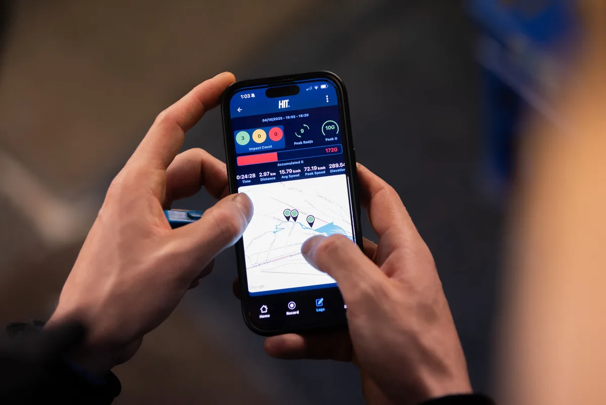 Smartphone showing HIT app with impact data, ride stats and mapped route