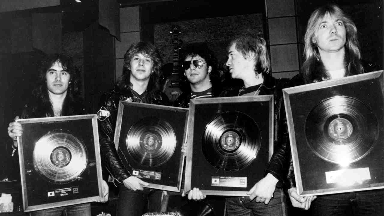 Iron Maiden posing for a photograph with silver discs in 1981