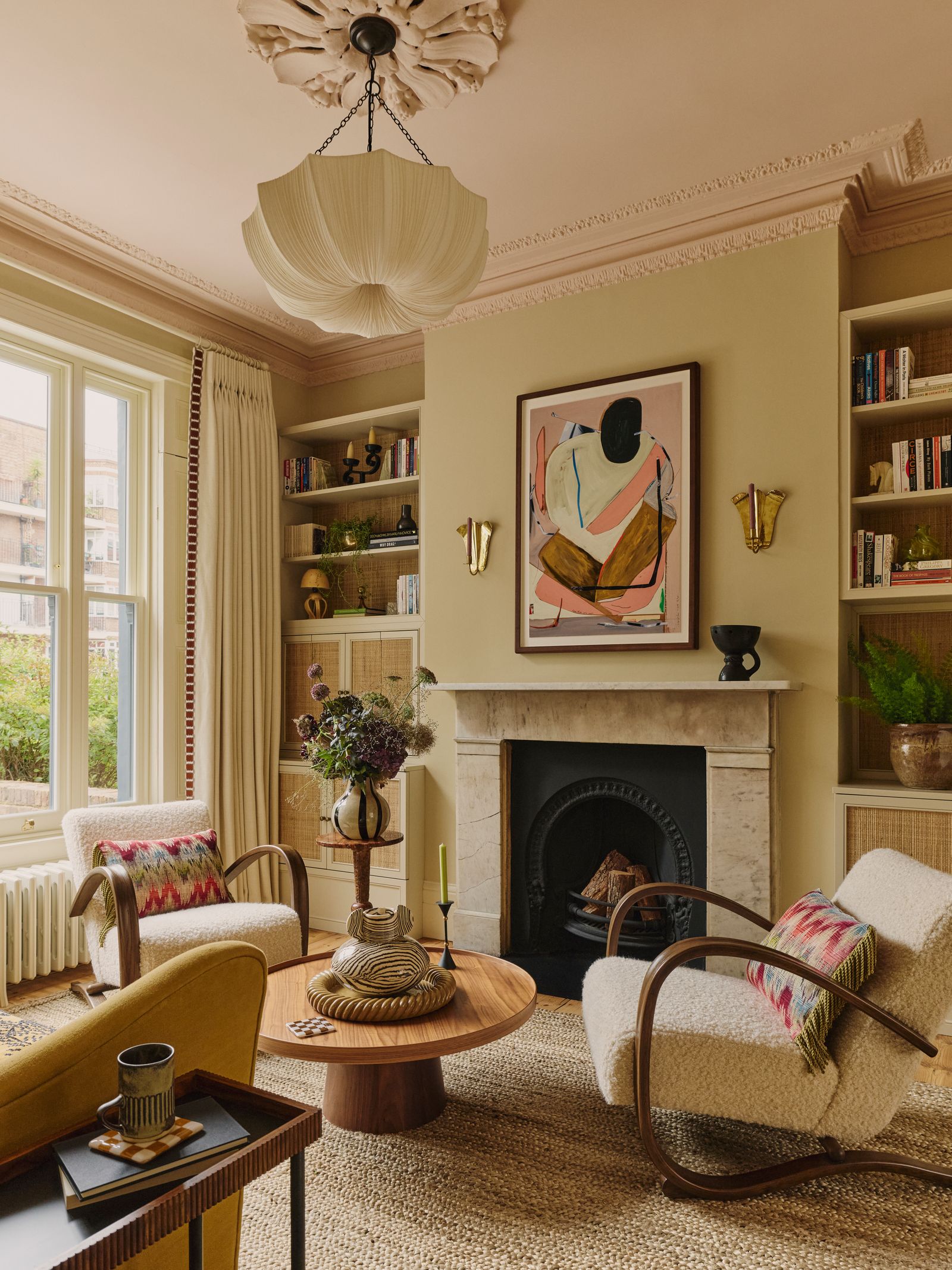 Image may contain Home Decor Plant Furniture Chair Lamp Art Painting and Candle