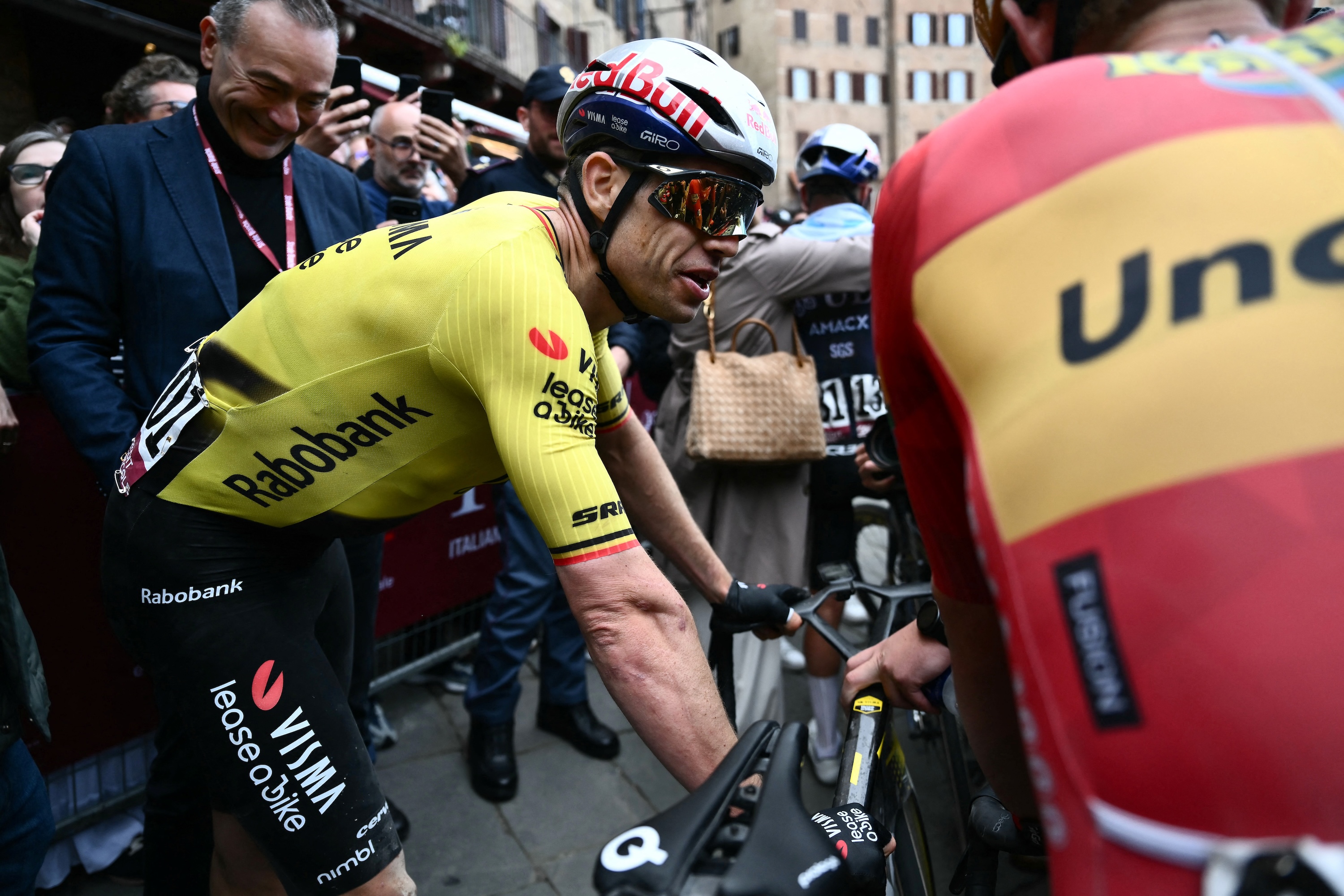 Team Visma | Lease a Bike TVL's Belgian Wout Van Aert reacts after crossing the finish line of the 20th one-day classic 'Strade Bianche' (White Roads) men's cycling race between Siena and Siena in Tuscany on March 7, 2026. (Photo by Marco BERTORELLO / AFP)
