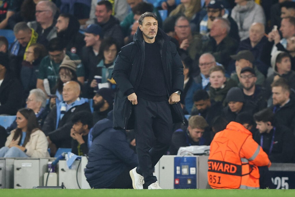 Borussia Dortmund manager Niko Kovac stands in the rain on the touchline.