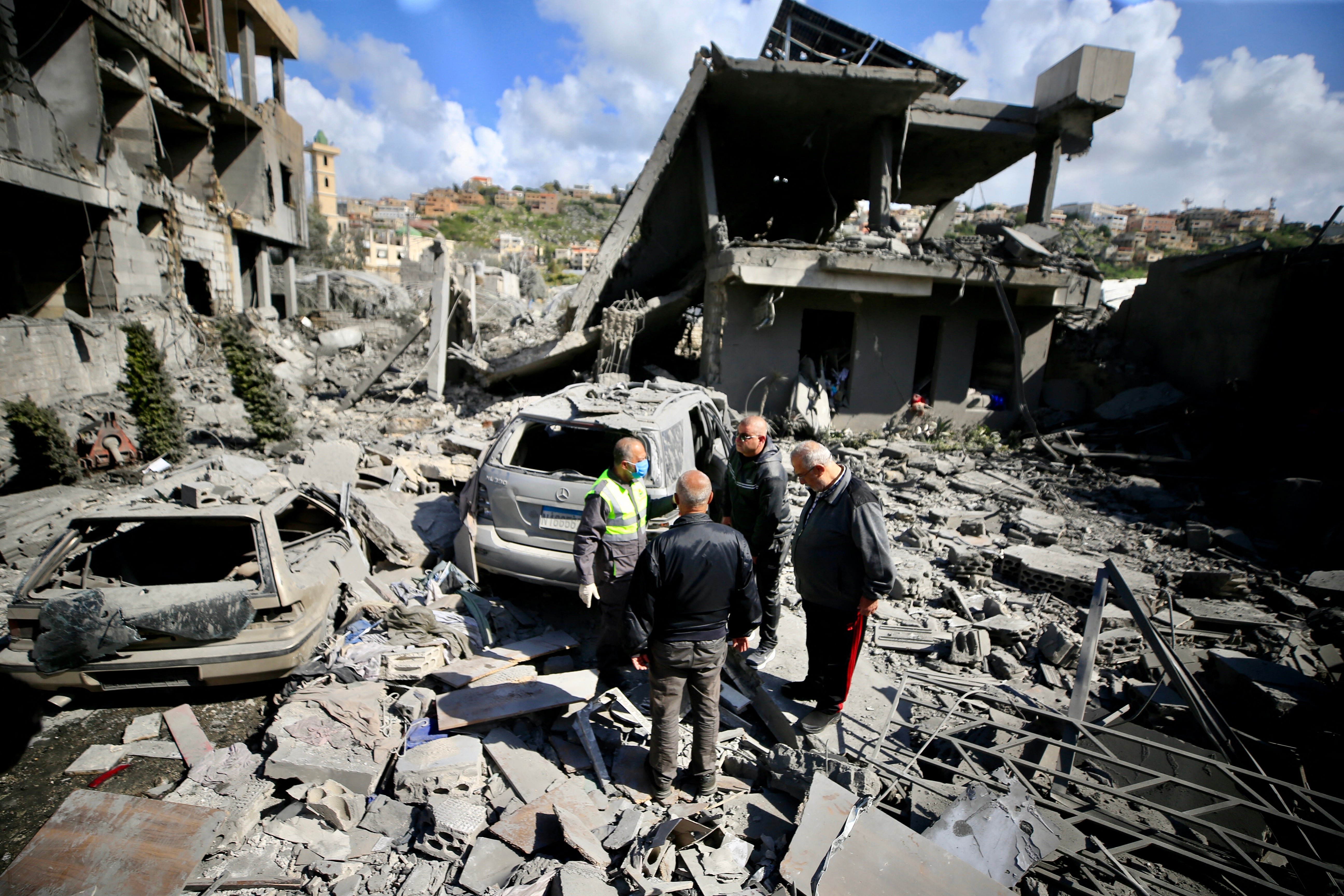 First aid responders inspect the site of an Israeli airstrike that targeted a building in the southern Lebanese town of Saksakiyeh