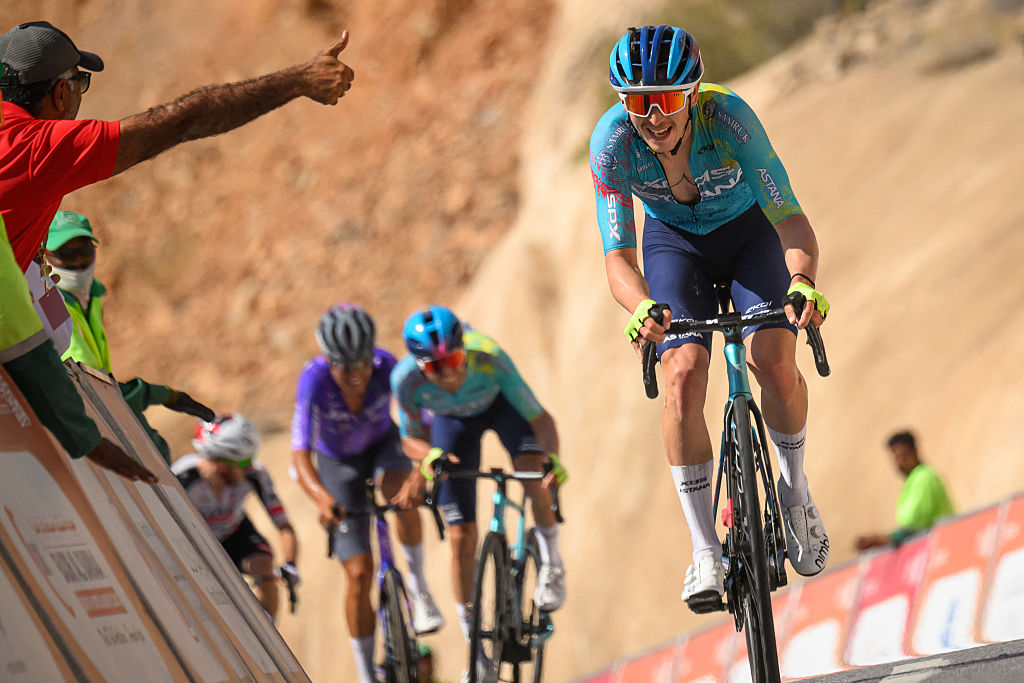 XDS Astana Team's Italian rider Christian Scaroni celebrates while crossing the finish line to win the 5th and last stage, and be winner overall of the Tour of Oman cycling race from Nizwa to Green Mountain, on February 11, 2026. (Photo by Loic VENANCE / AFP)