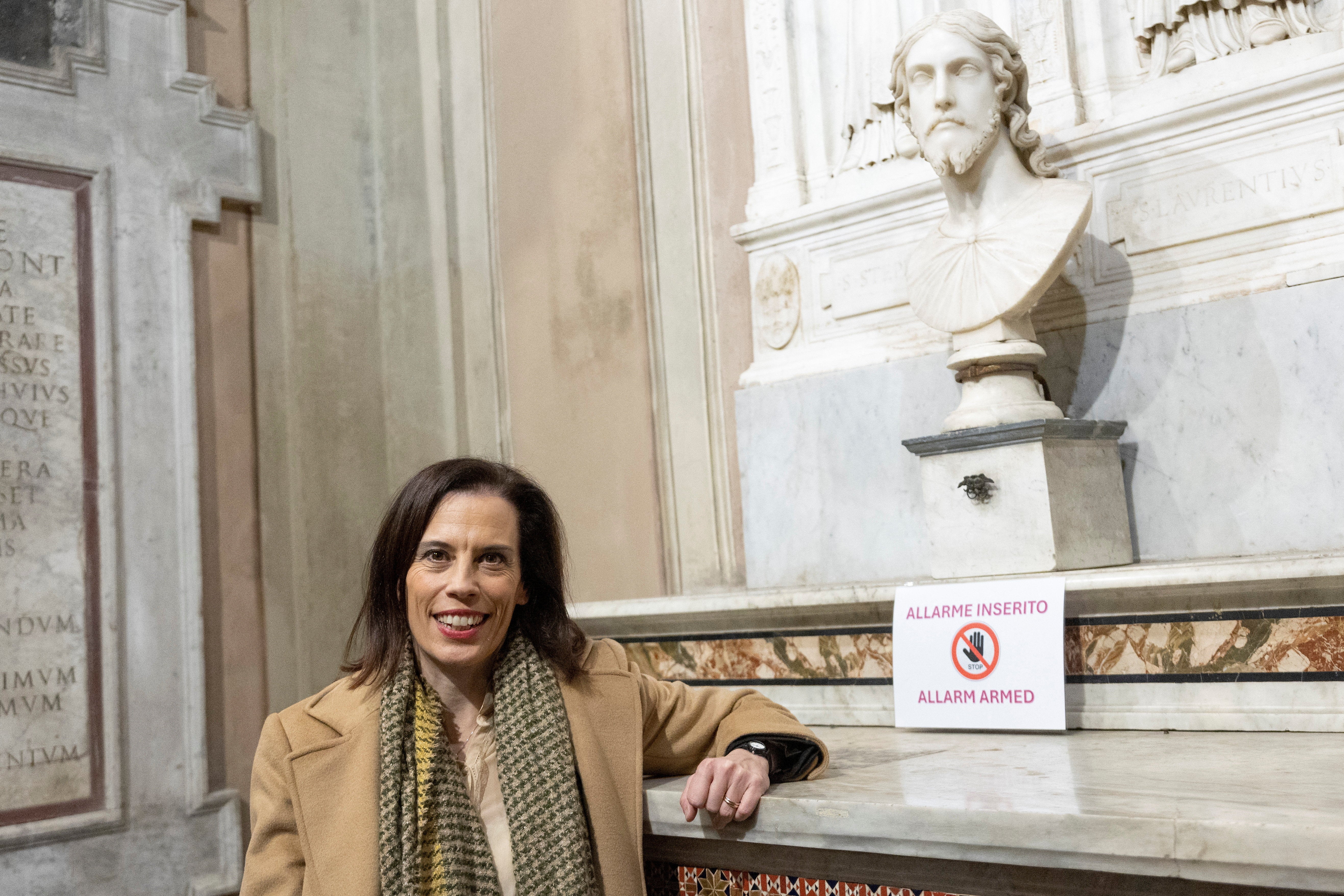 Researcher Valentina Salerno poses for photos next to the bust she identified as a work by Michelangelo Buonarroti, following a decade of archival research