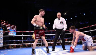 Pierce O’Leary standing over Maxi Hughes during a knockdown in their super lightweight title fight.