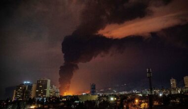 Damaged oil facility in Iran with smoke and debris following a strike, highlighting impact on energy infrastructure and re...