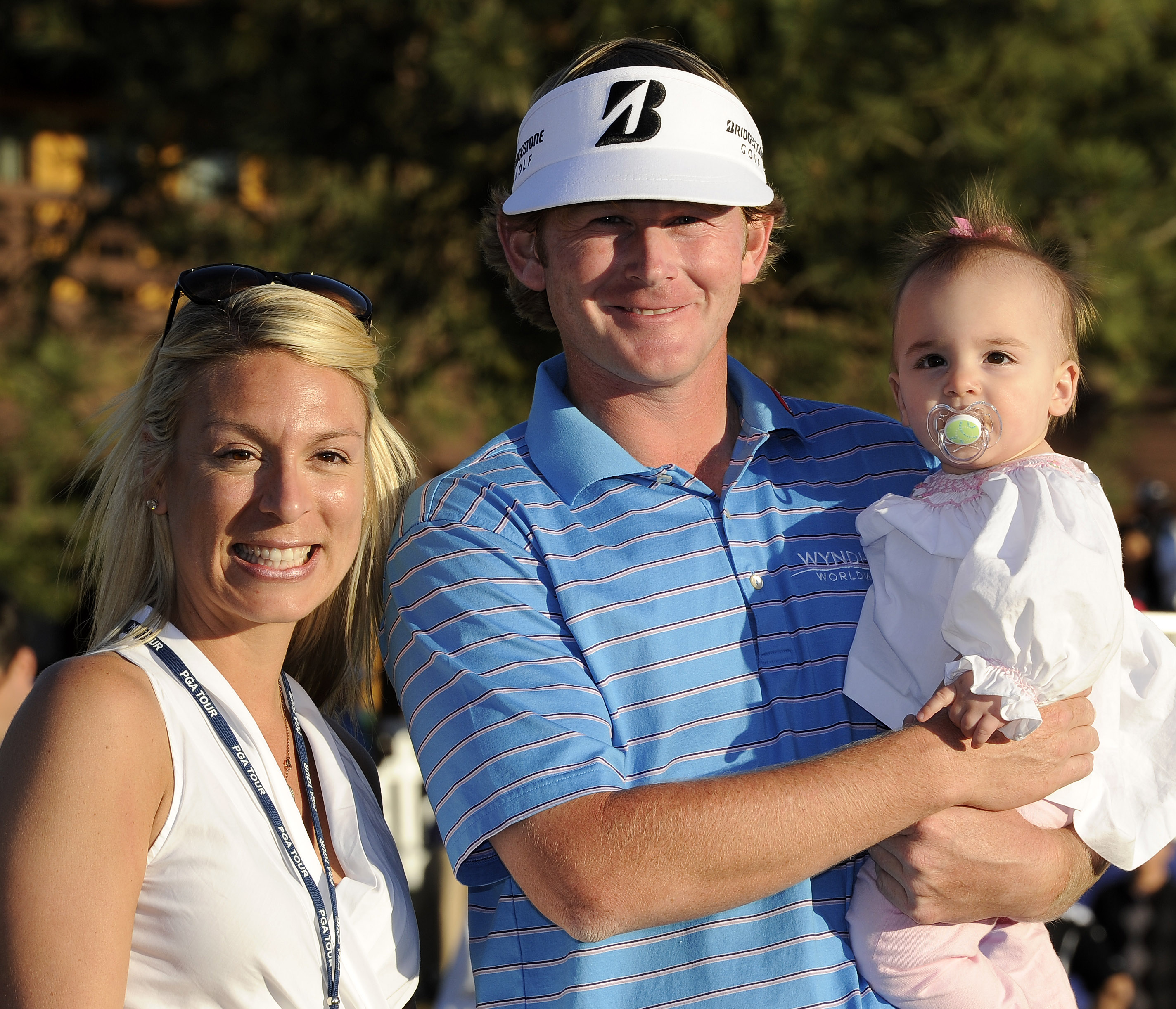 Mandy Snedeker (left) stands next to Brandt who is holding their daughter Lily at the 2012 FedEx Cup