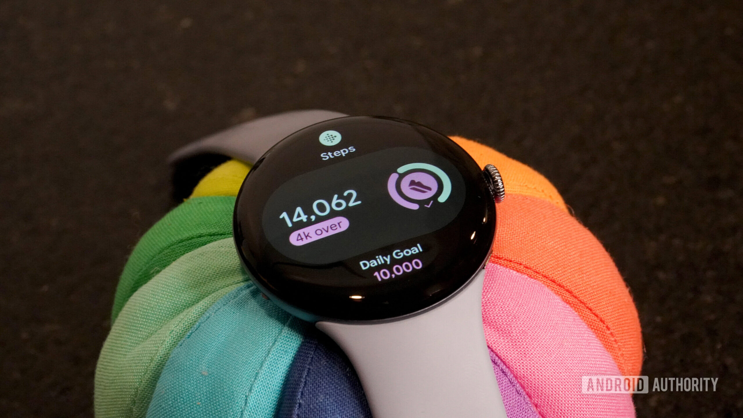 A Pixel Watch 4 displays a user's step count