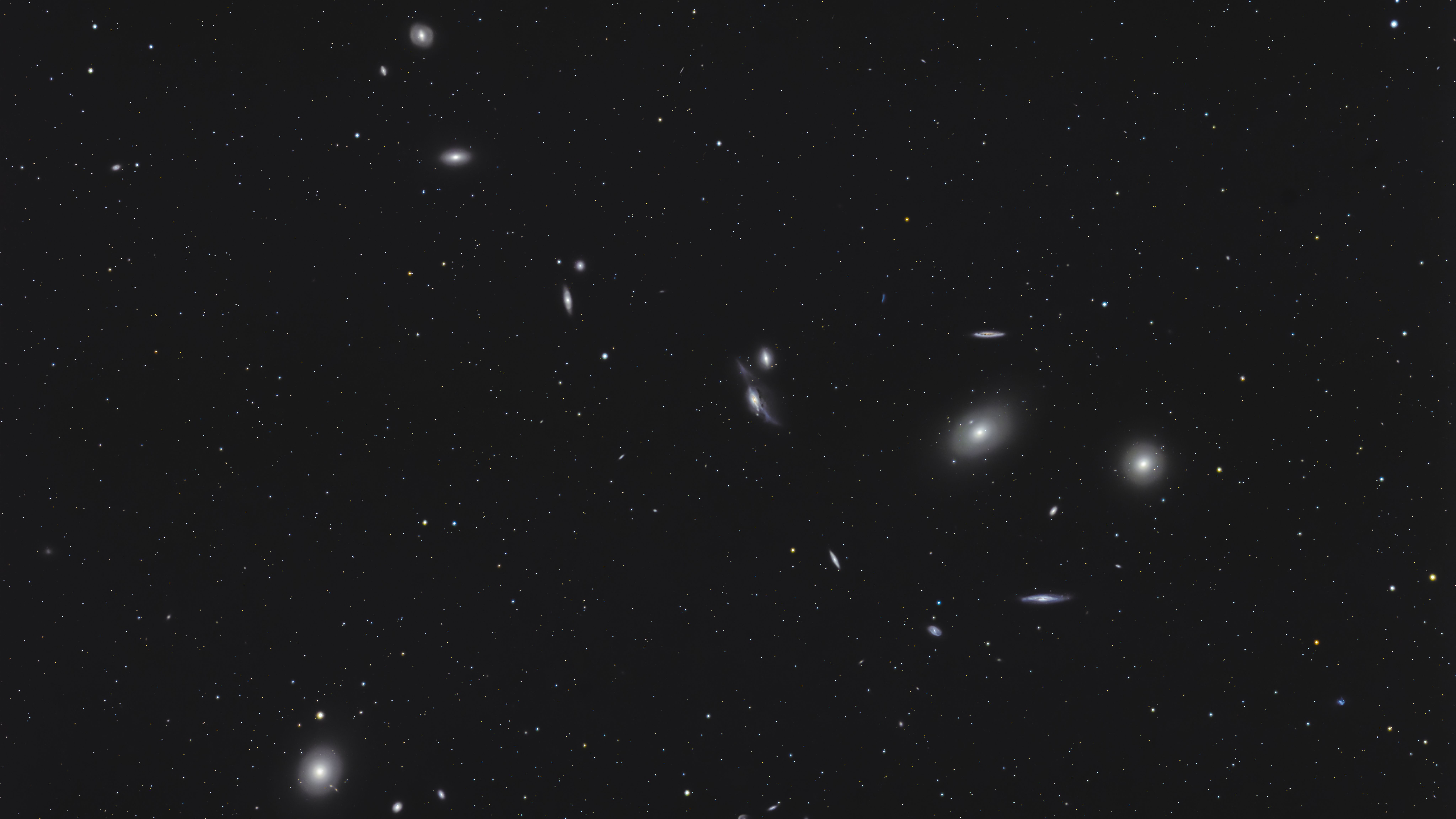 Galaxies are pictured shining in the blackness of space.