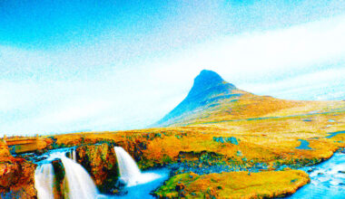 A grassy landscape with a small waterfall in the foreground and a distinctively shaped mountain under a bright, mostly clear sky.