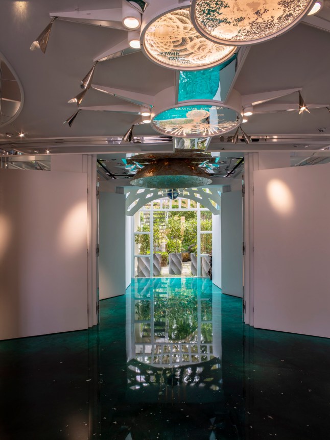 The new Exhibition Room with the evolution of scientific representations of the sun in the ceiling lights, looking out to the Time Garden, with a malachite floor and sculpture by Charles and Lily Jencks of the sun and earth above. picture: Sue Barr