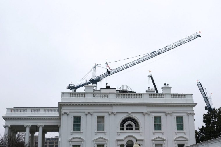 Construction cranes work on U.S. President Donald Trump???s ballroom project overtop the White House in Washington, D.C., U.S., March 6, 2026. REUTERS/Jonathan Ernst