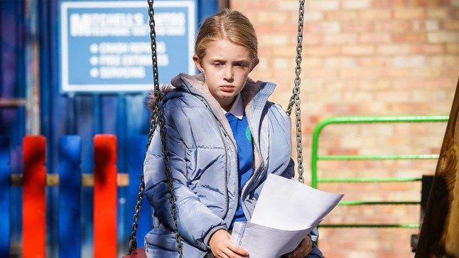 Lexi sat on a swing in EastEnders