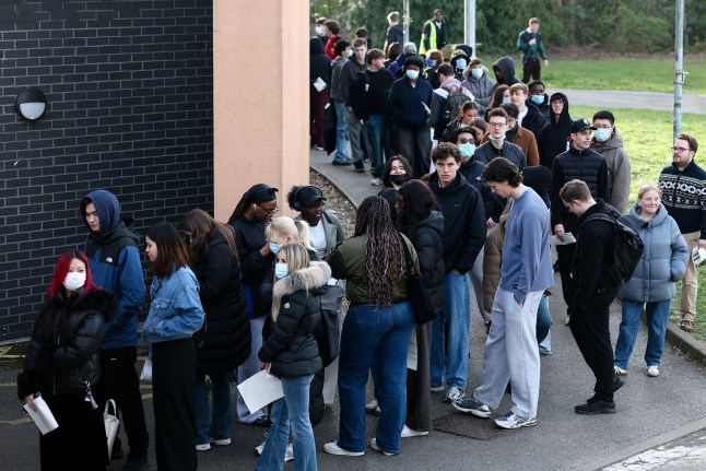 People, mainly students, queue to receive Meningitis B vaccinations at a sports centre on the University of Kent campus, following an outbreak of meningitis cases in Kent, in Canterbury, Britain, March 20, 2026. REUTERS/Toby Melville