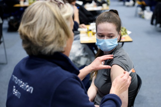 Natalie Allgrove, of the Kent Community Health NHS Trust immunisation team, administers a Meningitis B vaccination to student May Croxton, at a sports centre on the University of Kent campus, following an outbreak of meningitis cases in Kent, in Canterbury, Britain, March 20, 2026. REUTERS/Toby Melville TPX IMAGES OF THE DAY