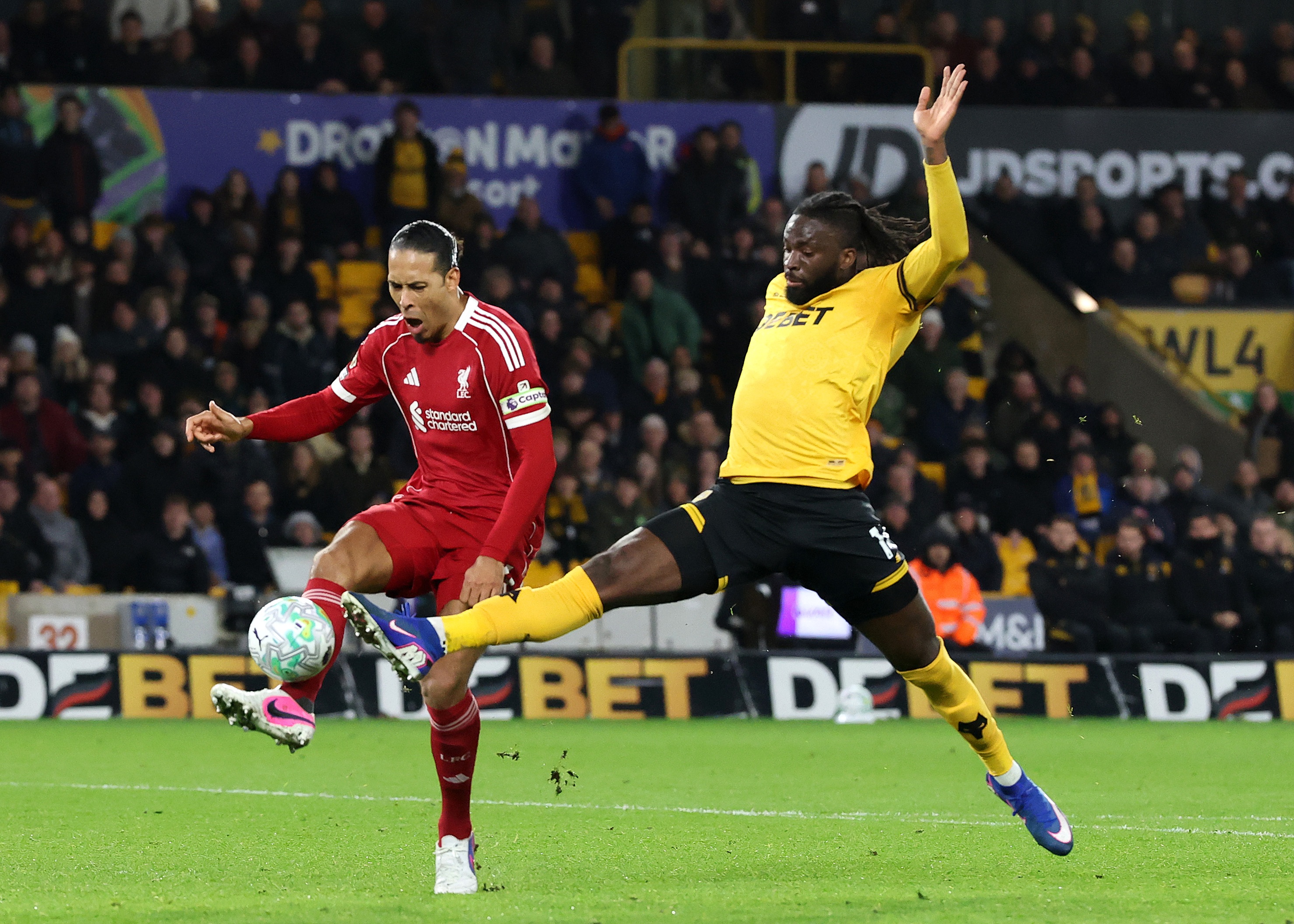 Virgil van Dijk is challenged by Tolu Arokodare.