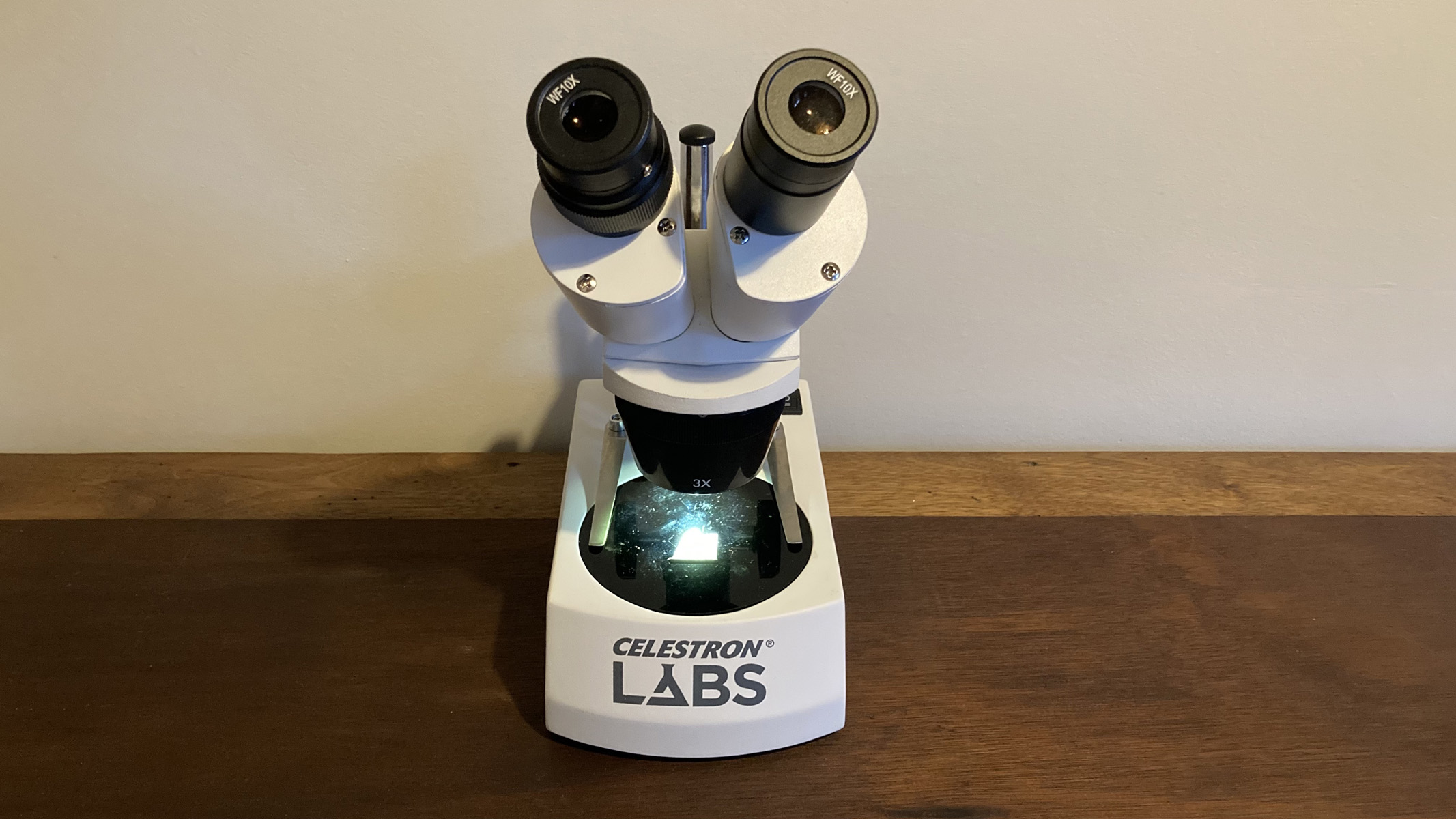 A Celestron Labs S10-60 stereo microscope on a desk.