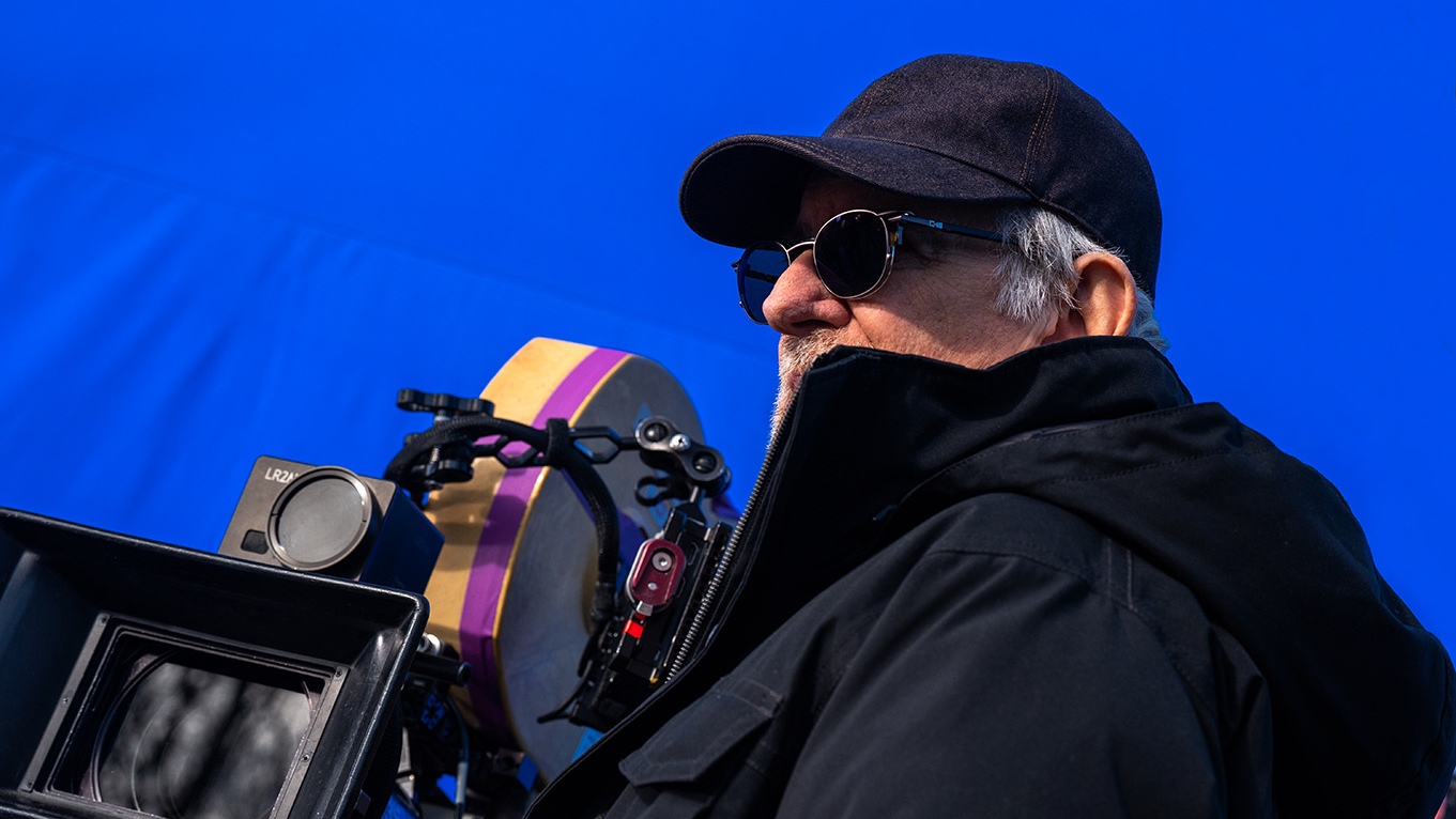 a film director in a hat and sunglasses on set