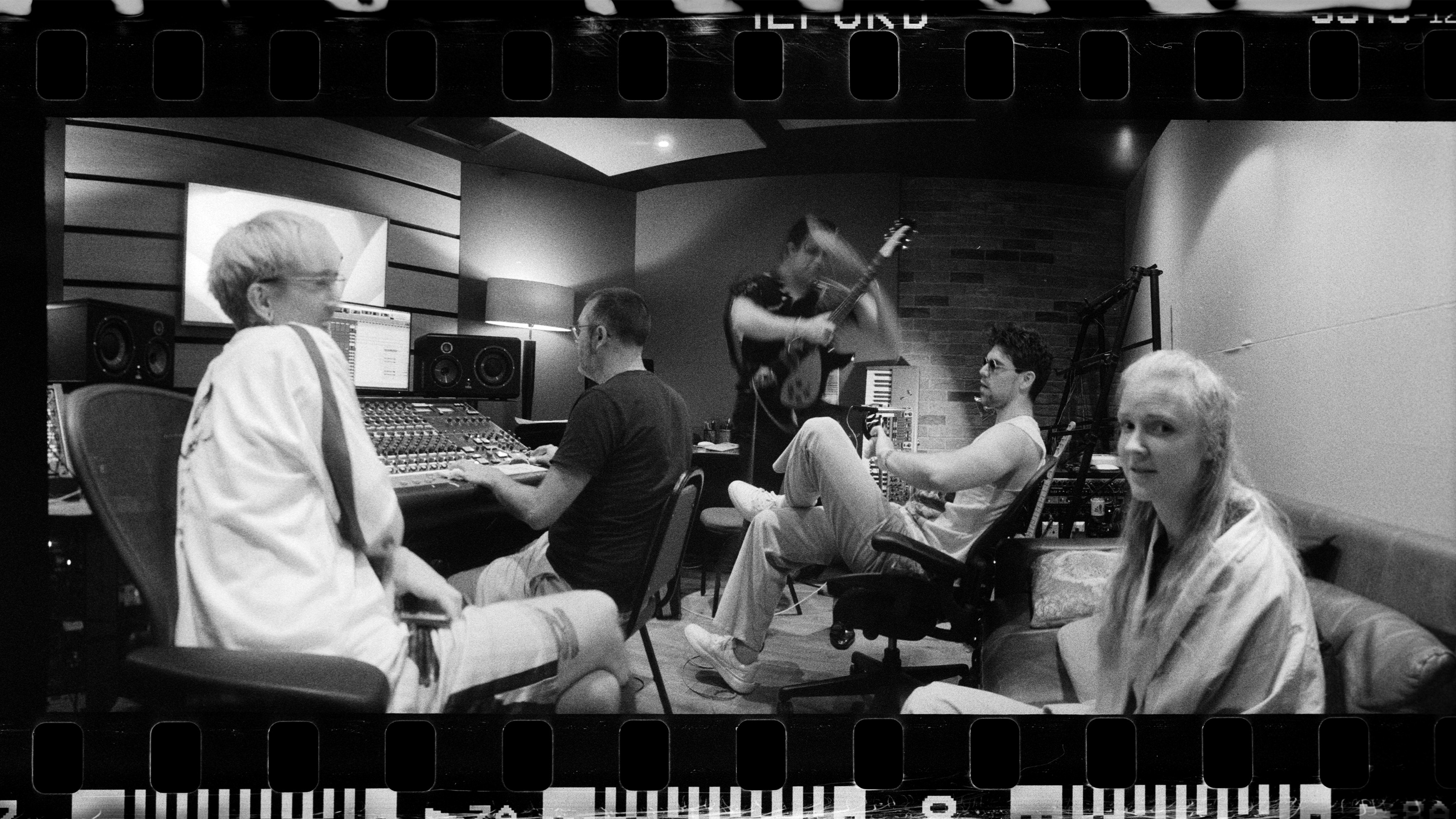 A band rehearsing in a studio.