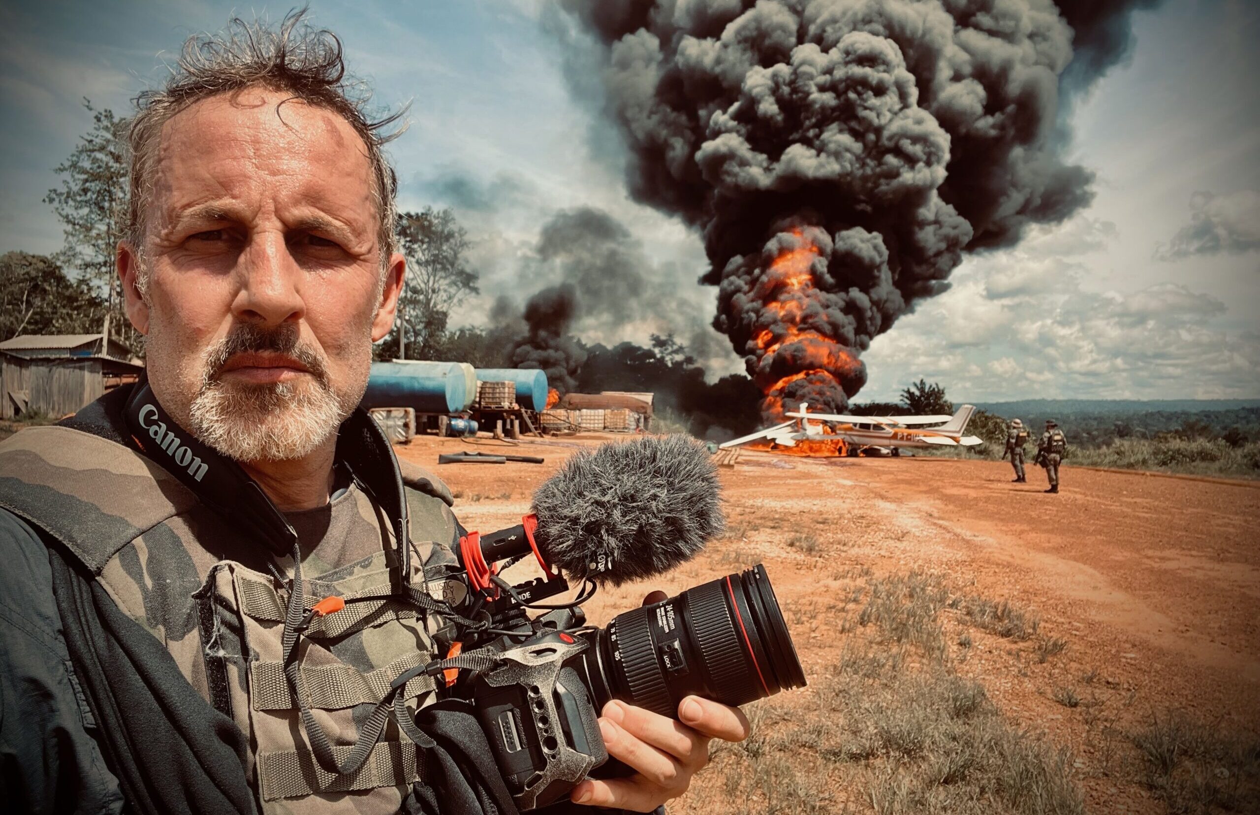 Richard Ladkani in front of burning plane. Image © Malaika Pictures.