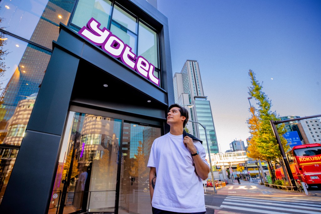 Guest outside Yotel building entrance