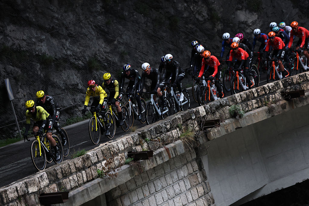 Team Visma - Lease a Bike's Danish rider Jonas Vingegaard (3rd L), wearing the overall leader yellow jersey, cycles with the pack during the 7th stage of the Paris-Nice cycling race, 47 km between Le Broc and Isola-Village, on March 14, 2026. Due to deteriorating weather conditions, the route of stage 7 has been changed to a 47 km race from Le Broc to Isola. (Photo by Anne-Christine POUJOULAT / AFP)