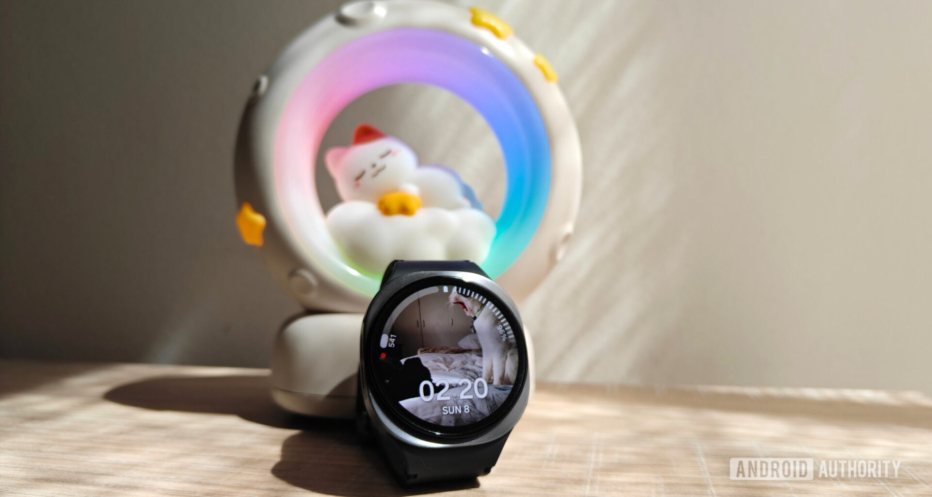 a galaxy watch 8 in front of a night light with a cat sleeping on a moon
