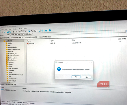 A laptop screen displaying the RegCool interface with an Undo confirmation dialog box active.