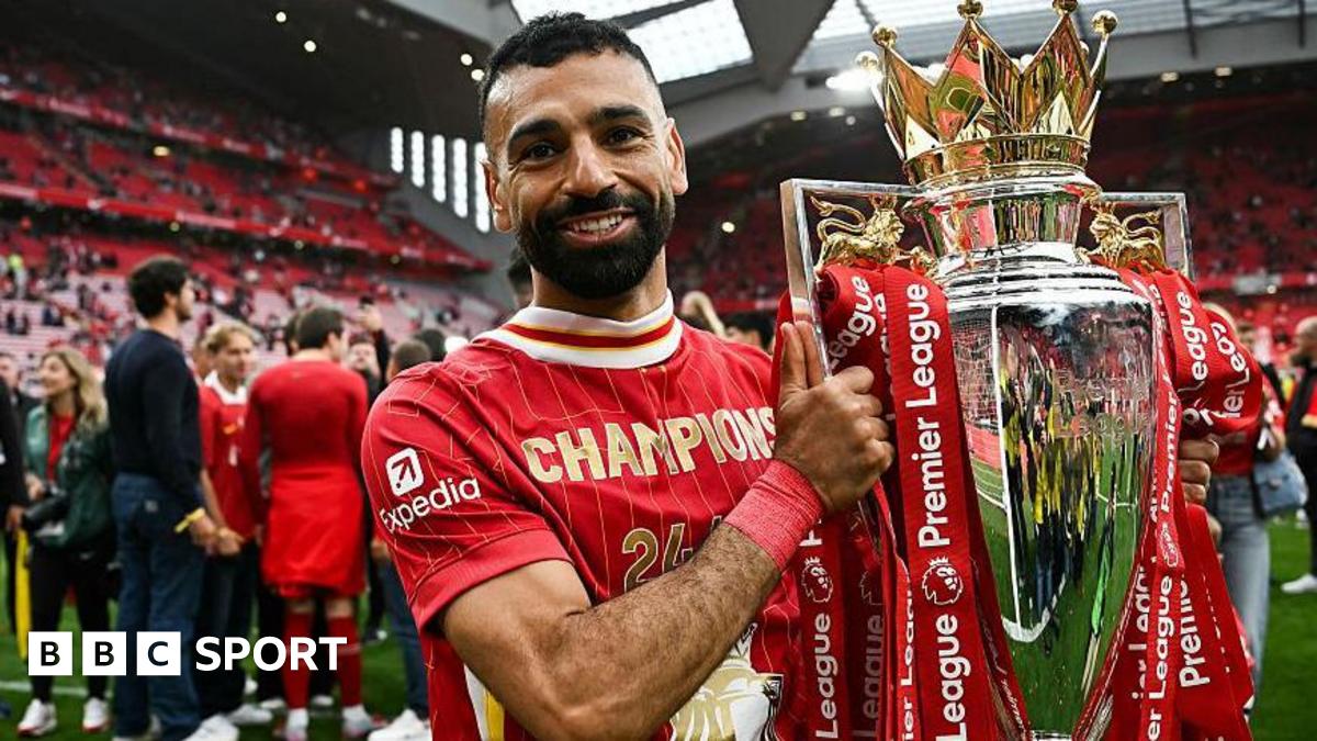 Mohamed Salah poses with the Premier League trophy