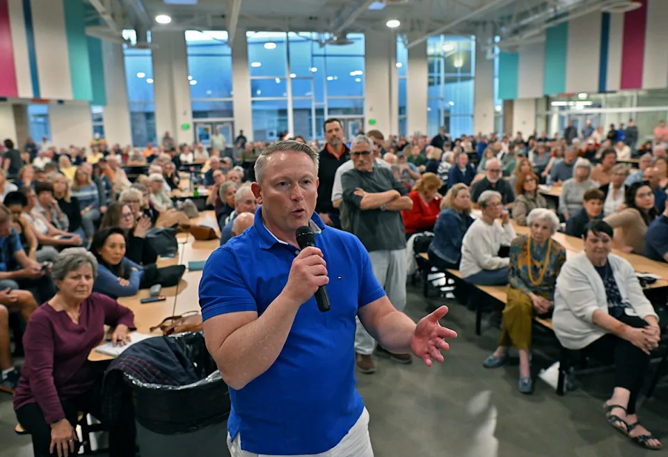 Sean McCaffrey, a candidate for Sparks City Council Ward 4, shares his thoughts at the Wingfield Springs Community meeting at the Sky Ranch Middle School cafeteria on Thursday, March 12, 2026. The meeting discussed a proposal to build housing at Red Hawk Golf property.