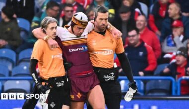 George Flanagan is helped from the field having been injured in Huddersfield's loss to Hull KR on Sunday