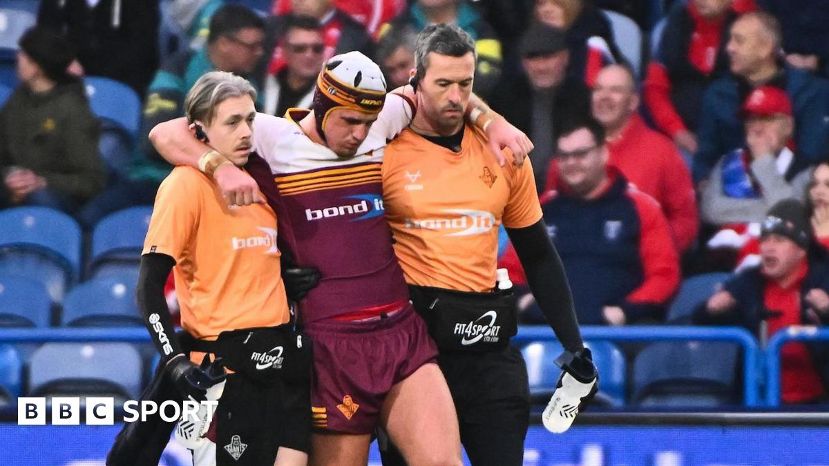 George Flanagan is helped from the field having been injured in Huddersfield's loss to Hull KR on Sunday