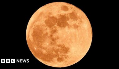 Full moon with red tint. Taken from Hartlepool. The sky surrounding the moon is pitch black.