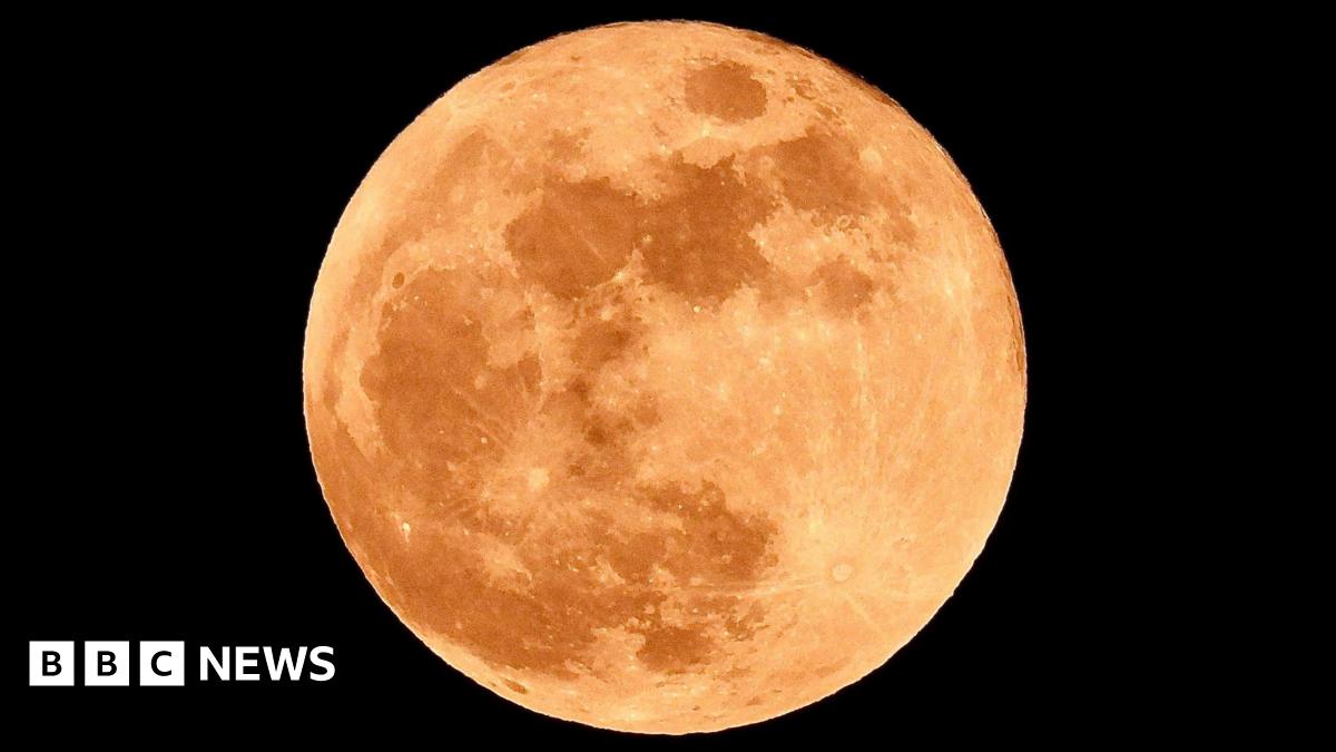 Full moon with red tint. Taken from Hartlepool. The sky surrounding the moon is pitch black.