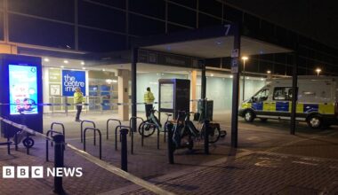 A police cordon outside the entrance to the Centre:MK. There are two police officers in yellow high vis jackets and a police van.