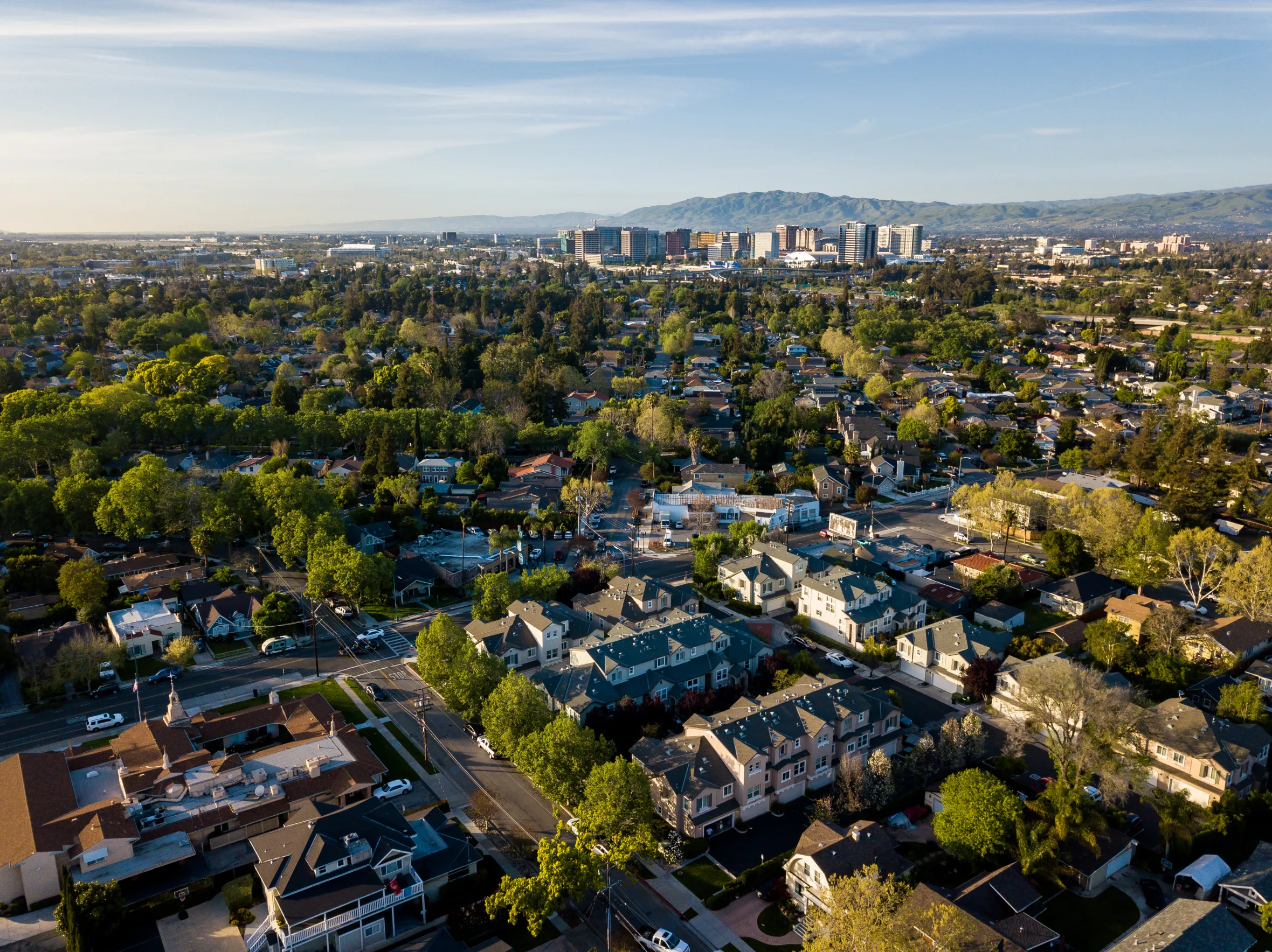Aerial view of Silicon Valley in California, showing residential areas and distant city buildings.