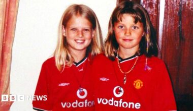 Members of the Soham community form a long queue to get into a church, following the murder of Holly Wells and Jessica Chapman. There are large piles of flowers laid out on the floor of the churchyard.