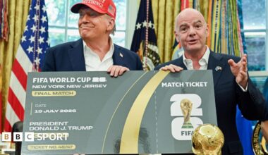 US President Donald Trump and Uefa president Gianni Infantino pose with a giant mock World Cup ticket