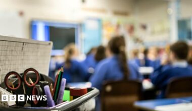 A blurred out image of children in a classroom