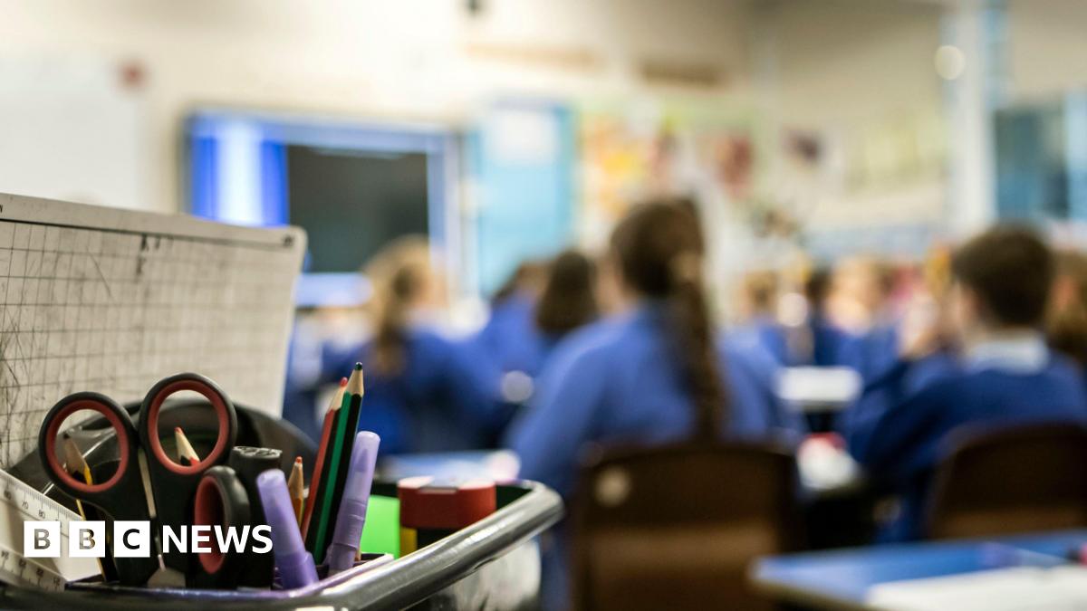 A blurred out image of children in a classroom