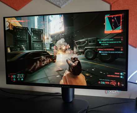 Alienware AW2725Q on a desk running Cyberpunk 2077
