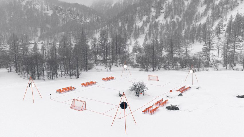 Orange football pitch in snowy landscape