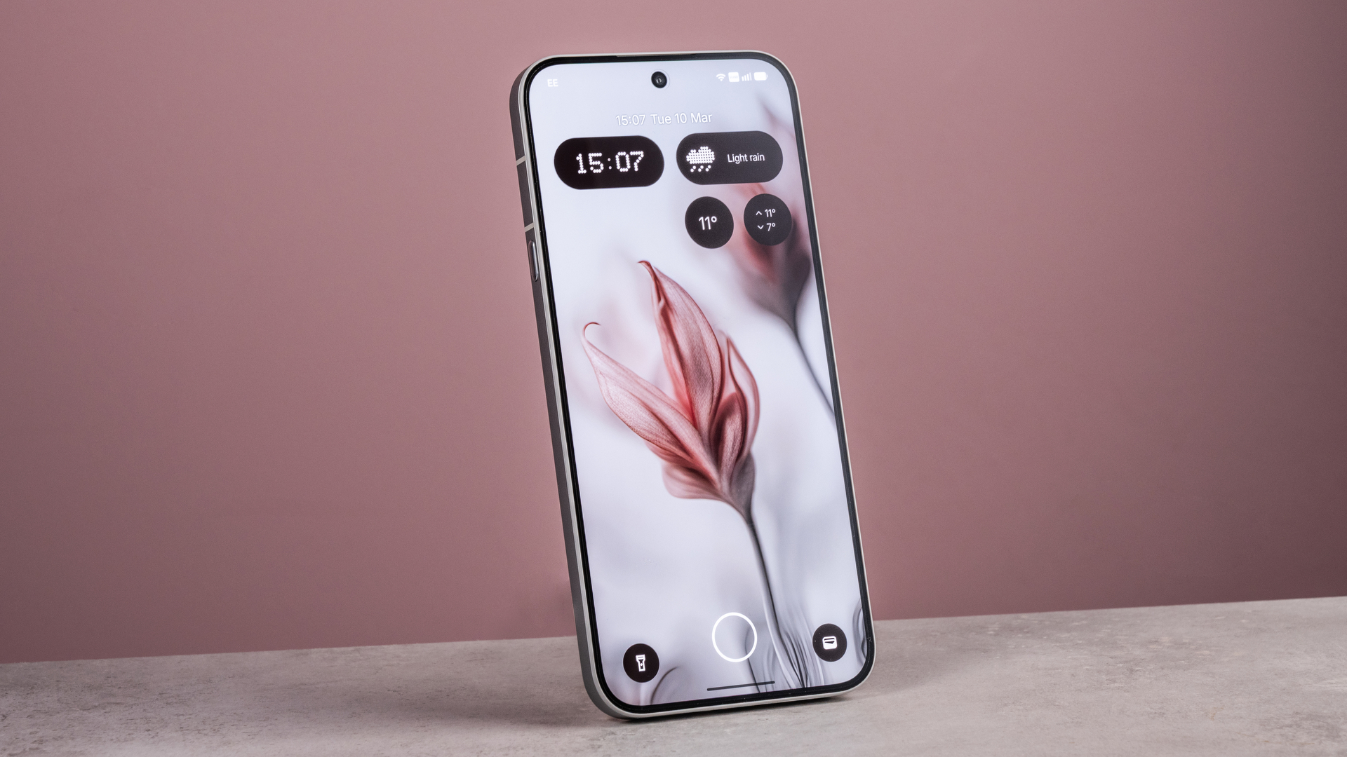 The Nothing Phone (4a) Pro's home screen featuring an AI image of flowers, in front of a pink background.