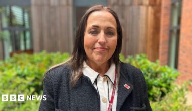 A woman wearing a black jumper and white top, as well as a Worcestershire County Council lanyard.