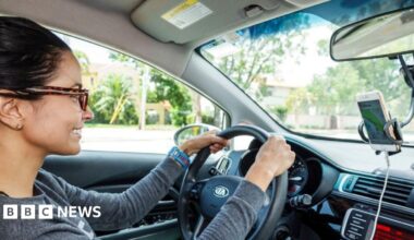 A female Uber driver in Miami Beach, Florida, driving