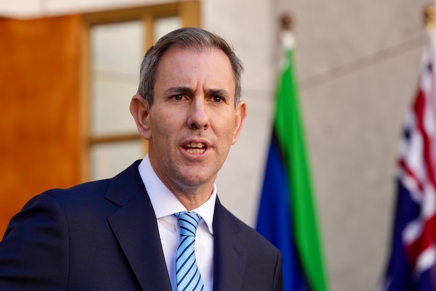 Men in suits speak at a press conference