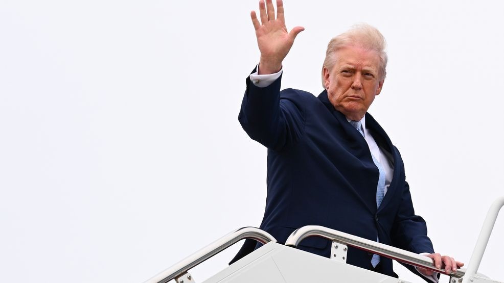 FILE - President Donald Trump waves as he boards Air Force One on March 20, 2026 at Joint Base Andrews, Maryland. (Photo by Roberto Schmidt/Getty Images)