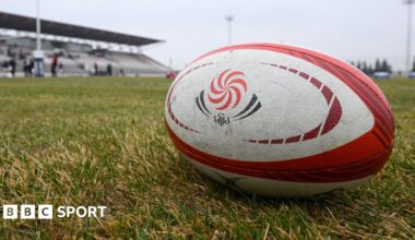 A Georgia rugby ball sits on a pitch