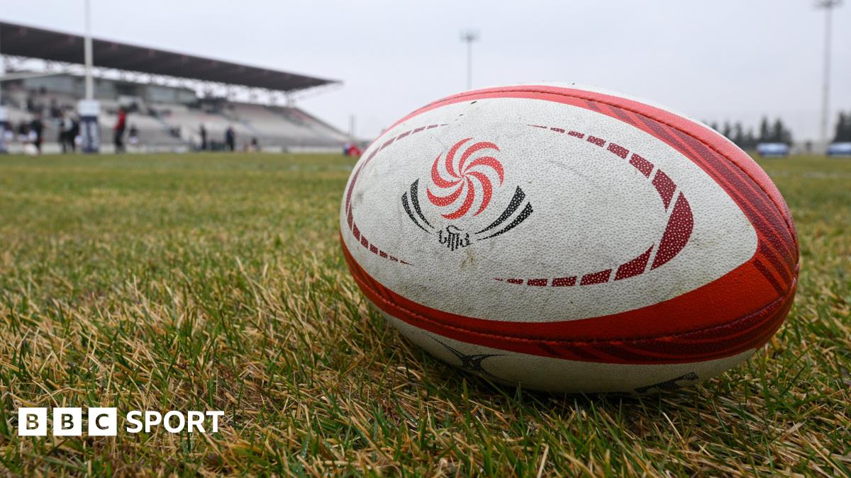 A Georgia rugby ball sits on a pitch